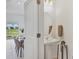 Elegant powder room with pedestal sink and decorative mirror at 8733 Winter Breeze Way, Sarasota, FL 34241