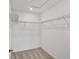 Bright walk-in closet with carpet floors and wire shelving storage system at 8733 Winter Breeze Way, Sarasota, FL 34241