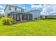 View of the large yard with a covered patio, perfect for enjoying time outdoors at 9040 Tequila Sunrise Dr, Sarasota, FL 34241
