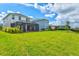 Large backyard with green grass and a screened-in patio, perfect for outdoor entertaining at 9040 Tequila Sunrise Dr, Sarasota, FL 34241