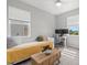 Bright bedroom featuring a bed, work desk, and comfortable seating area with natural light at 9040 Tequila Sunrise Dr, Sarasota, FL 34241