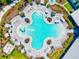An aerial view of a large resort style clover-shaped pool surrounded by lounge chairs and lush landscaping at 9040 Tequila Sunrise Dr, Sarasota, FL 34241