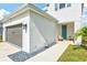 Inviting front entryway with a covered porch, stylish seating, and a well-maintained landscape at 9040 Tequila Sunrise Dr, Sarasota, FL 34241