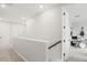 Upstairs hallway showcasing an open doorway to an entertainment space with a drum set and guitars at 9040 Tequila Sunrise Dr, Sarasota, FL 34241