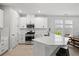 Modern kitchen featuring white cabinetry, a large island, and stainless steel appliances at 9040 Tequila Sunrise Dr, Sarasota, FL 34241