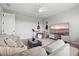 Spacious living room with a sectional sofa, sleek coffee table, TV and musical instruments at 9040 Tequila Sunrise Dr, Sarasota, FL 34241