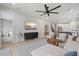 Spacious living room with tv, sleek entertainment center, open floor plan and access to the bedroom at 9040 Tequila Sunrise Dr, Sarasota, FL 34241