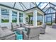 Covered patio boasts comfortable seating and serene backyard views through large sliding glass doors at 9040 Tequila Sunrise Dr, Sarasota, FL 34241