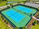 An aerial view of well maintained tennis courts surrounded by lush landscaping at 9040 Tequila Sunrise Dr, Sarasota, FL 34241
