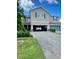 Exterior showcasing a townhome with a blue garage door, stone accents, and well-maintained landscaping at 11613 Woodleaf Dr, Lakewood Ranch, FL 34211