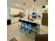 Bright kitchen with white cabinets, stainless steel appliances, an island with bar seating and pendant lighting at 11613 Woodleaf Dr, Lakewood Ranch, FL 34211