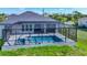 Aerial view of a private home with a screened-in pool and landscaped yard, enhancing the outdoor living experience at 1167 Boundary Blvd, Rotonda West, FL 33947