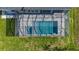 Aerial view of a modern home with a screened pool, patio area, and well-manicured lawn at 1167 Boundary Blvd, Rotonda West, FL 33947