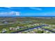 Scenic aerial view of a residential community surrounded by waterways and lush green spaces with a coastal backdrop at 1167 Boundary Blvd, Rotonda West, FL 33947
