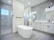 Elegant bathroom featuring a soaking tub, double vanity with marble countertops, and a walk-in shower at 1167 Boundary Blvd, Rotonda West, FL 33947