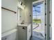 Bathroom with white vanity, marble countertop, square mirror, and a view to an outdoor pool at 1167 Boundary Blvd, Rotonda West, FL 33947