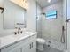 Bright bathroom features marble counters, bronze fixtures, and a glass shower with a window at 1167 Boundary Blvd, Rotonda West, FL 33947
