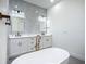 A lavish bath boasts a double vanity with marble countertops and mosaic backsplashes, and bronze fixtures at 1167 Boundary Blvd, Rotonda West, FL 33947