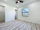 Bedroom boasts a modern ceiling fan, wood-look floors, and doors to the closet and bath at 1167 Boundary Blvd, Rotonda West, FL 33947