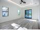 Bright bedroom with a ceiling fan, two windows providing ample natural light, and sliding glass doors at 1167 Boundary Blvd, Rotonda West, FL 33947