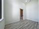 Bedroom has light wood grain floors, neutral colored walls, and a slider closet at 1167 Boundary Blvd, Rotonda West, FL 33947