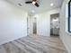 Bedroom features wood-look floors, a ceiling fan, and doors to the bathroom and closet at 1167 Boundary Blvd, Rotonda West, FL 33947
