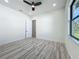Neutral bedroom boasts wood-look floors, bright light, and a view of green scenery at 1167 Boundary Blvd, Rotonda West, FL 33947