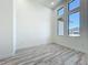 Bright bedroom features unique windows, wood grain floors, and neutral color palette at 1167 Boundary Blvd, Rotonda West, FL 33947
