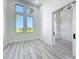 Bright bedroom with wood-look flooring, large windows, and barn-style door at 1167 Boundary Blvd, Rotonda West, FL 33947