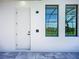 Modern home exterior featuring a secure door, contemporary windows, and smart home technology at 1167 Boundary Blvd, Rotonda West, FL 33947