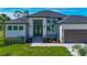 Beautiful single-story home with a three-car garage, stone accents, manicured lawn, and stylish entryway at 1167 Boundary Blvd, Rotonda West, FL 33947