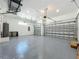 Spacious three-car garage with epoxy flooring and plenty of storage space at 1167 Boundary Blvd, Rotonda West, FL 33947