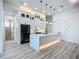 Bright kitchen featuring white cabinets, stone countertops, decorative lights, and stainless steel appliances at 1167 Boundary Blvd, Rotonda West, FL 33947
