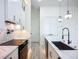 Modern kitchen featuring white cabinets, marble countertops, black hardware, and stainless steel appliances at 1167 Boundary Blvd, Rotonda West, FL 33947