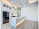 Spacious kitchen features modern white cabinetry, stone countertops, island with lights, and stainless steel appliances at 1167 Boundary Blvd, Rotonda West, FL 33947
