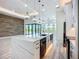 Open floor plan features a kitchen island, custom cabinets, and modern lighting at 1167 Boundary Blvd, Rotonda West, FL 33947