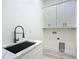 Bright laundry room with modern sink, countertop, white shaker cabinets, and black matte faucet at 1167 Boundary Blvd, Rotonda West, FL 33947