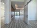 Bright living room featuring a wood-look accent wall, barn door, recessed lighting and sliding glass doors at 1167 Boundary Blvd, Rotonda West, FL 33947