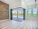 Bright living area showcasing wood-style flooring and large glass doors to the lanai and pool area at 1167 Boundary Blvd, Rotonda West, FL 33947