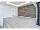 Spacious living room featuring hardwood-style flooring and decorative wood wall at 1167 Boundary Blvd, Rotonda West, FL 33947