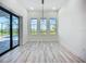 Living space features hardwood-style flooring and glass doors to the lanai and pool at 1167 Boundary Blvd, Rotonda West, FL 33947