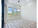 Bright living area featuring hardwood-style floors, large windows, and decorative lighting overlooking a pool at 1167 Boundary Blvd, Rotonda West, FL 33947