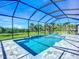 Stunning screened-in pool and spa area with lush greenery and a beautiful backyard view at 1167 Boundary Blvd, Rotonda West, FL 33947
