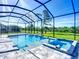 Relaxing pool and hot tub featuring a waterfall, surrounded by a screened enclosure and lush greenery at 1167 Boundary Blvd, Rotonda West, FL 33947