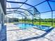 Inviting screened-in pool and spa area with clear blue water and a peaceful backyard view at 1167 Boundary Blvd, Rotonda West, FL 33947