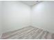 Small room showcasing a corner with white walls and baseboards, accented by wood-style flooring at 1167 Boundary Blvd, Rotonda West, FL 33947