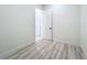 A serene view of the entryway leading to another room, framed by elegant white walls and flooring at 1167 Boundary Blvd, Rotonda West, FL 33947