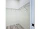 Small walk-in closet features wire shelving and matches the flooring in the bedroom at 1167 Boundary Blvd, Rotonda West, FL 33947