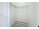 Small walk-in closet boasts wire shelving and wood-look floors at 1167 Boundary Blvd, Rotonda West, FL 33947