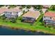 Aerial view of a home featuring a screened patio, pool, and lake view at 13220 Swiftwater Way, Lakewood Ranch, FL 34211